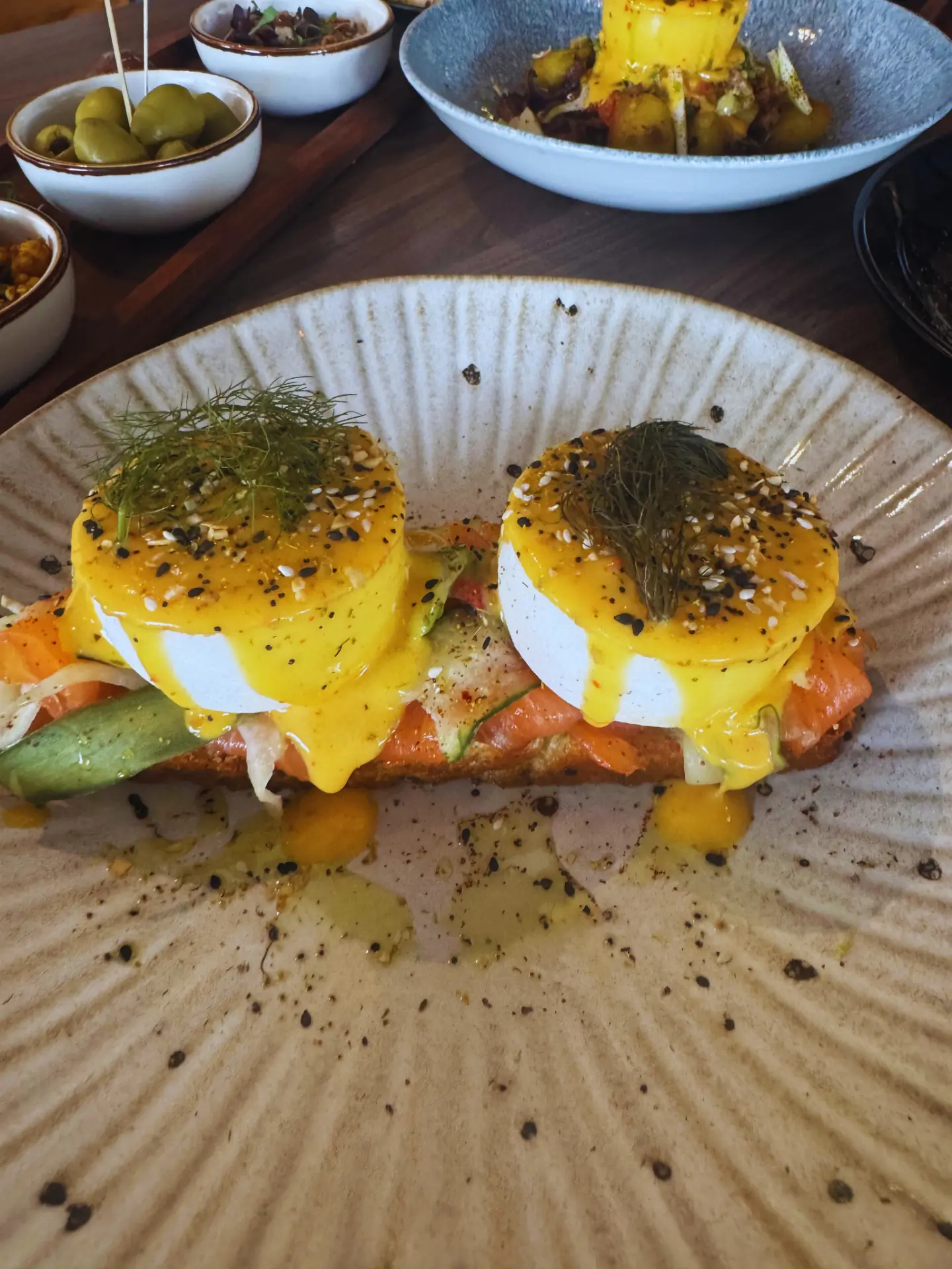 Smoked Salmon Royale, poached eggs with sumac hollandaise, dill and smoked salmon on toasted Eastern-style focaccia